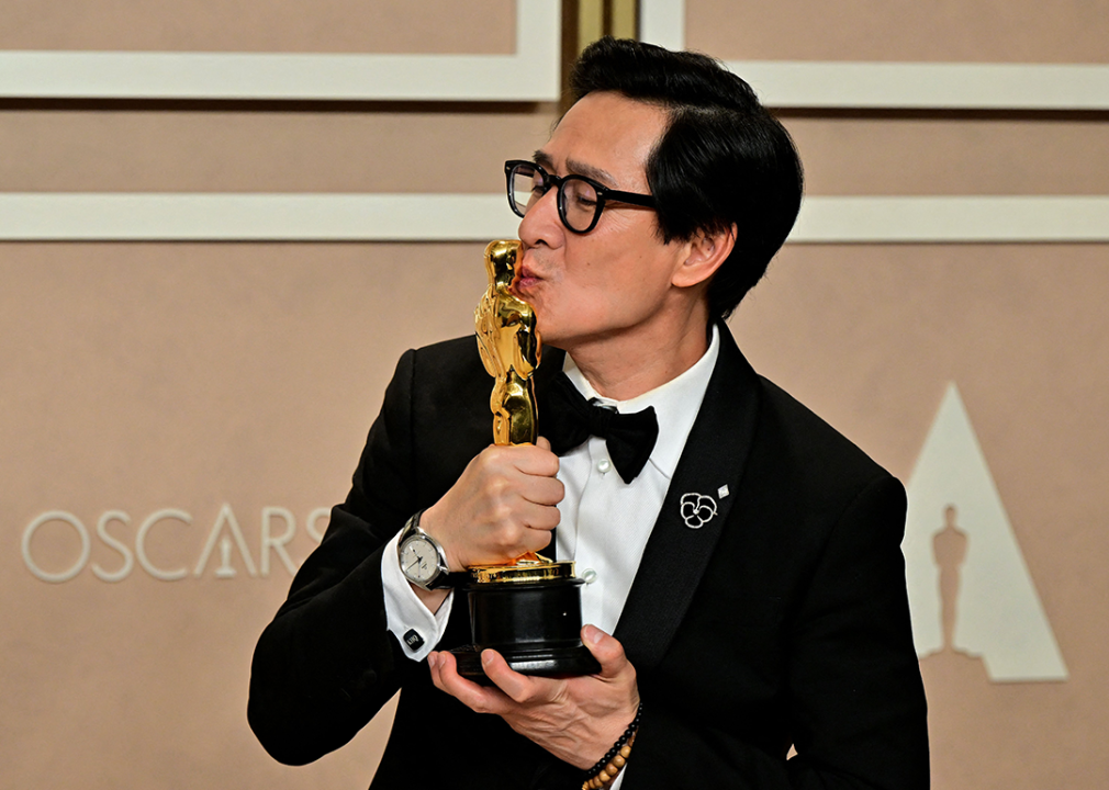 Ke Huy Quan poses with the Oscar for Best Actor in a Supporting Role.