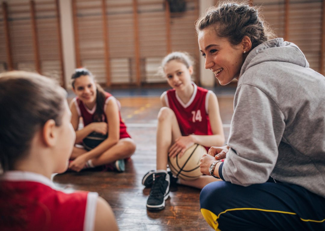 Recreation coach speaking with kids team