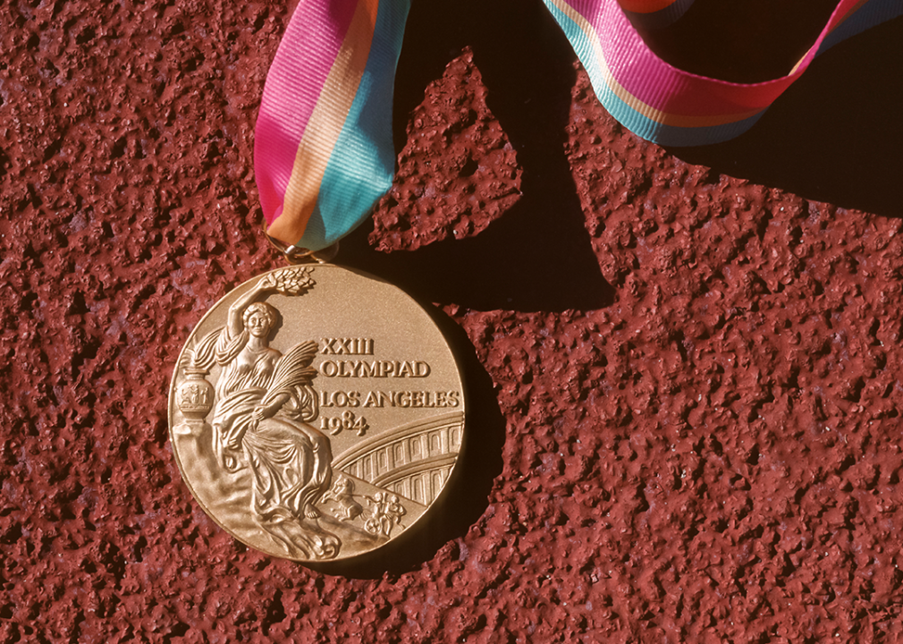 Close-up view of Los Angeles gold medal on paved surface.