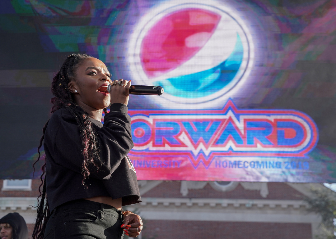 Gia Pepper speaks into a microphone at the Pepsi x ESSENCE She Got Now at Howard University Homecoming.