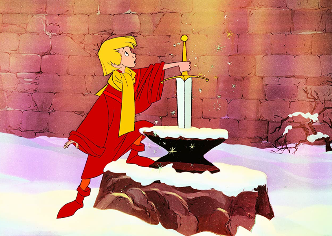 Illustrated still of a boy with his hand on the sword in a stone