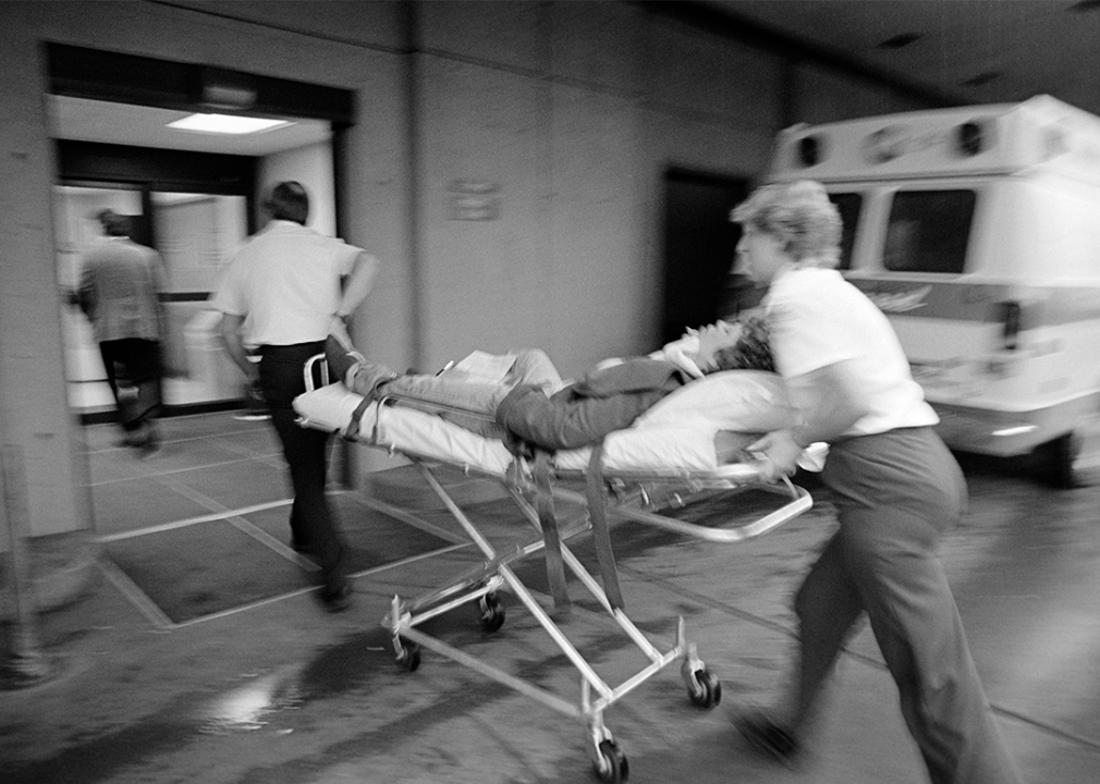 EMT team rushing a patient on a stretcher into the hospital.