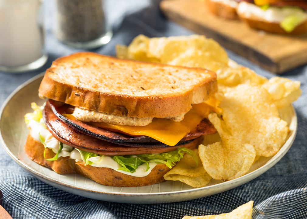 Fried bologna sandwich with cheese and lettuce.