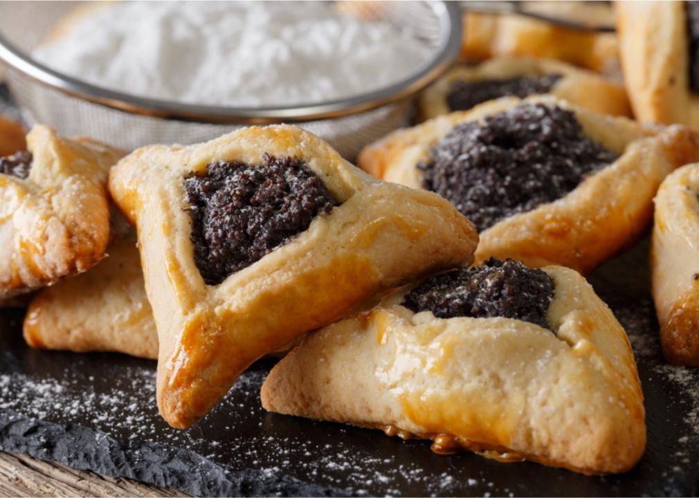 A close up of hamantaschen with a dark filling.
