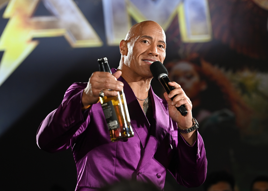 Dwayne Johnson with tequila bottle at premiere.