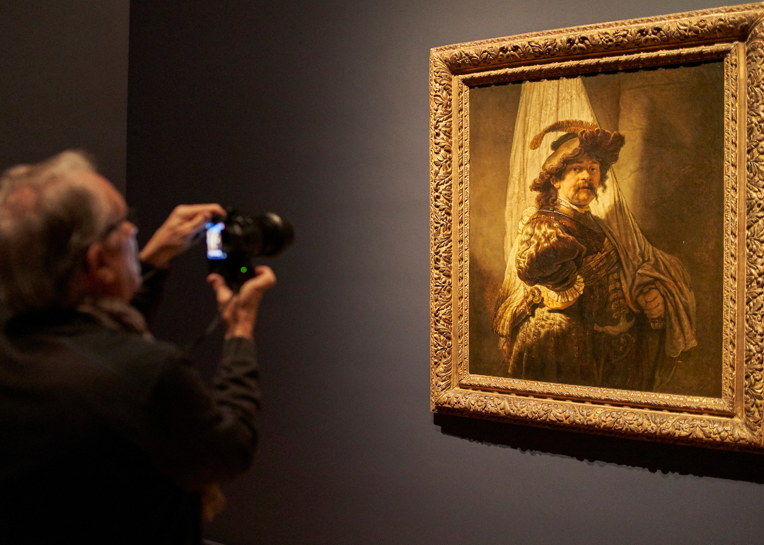 A visitor takes a photograph Rembrandt’s The Standard-bearer.