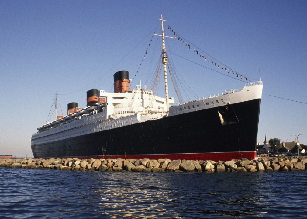 Exterior of The Queen Mary docked in Long Beach on a clear day.