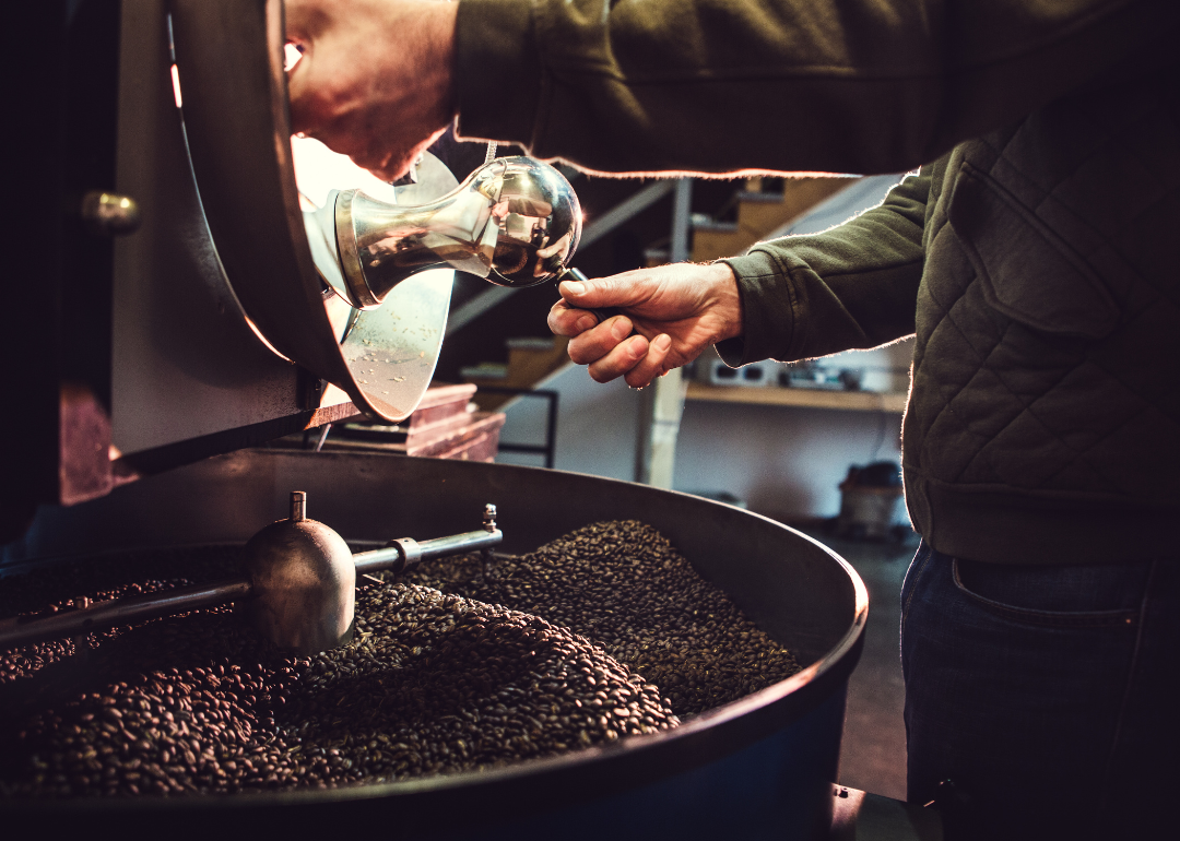 Roaster pouring beans onto cooling tray.