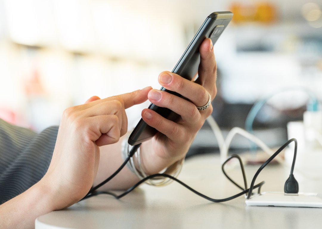 Person charging cellphone.