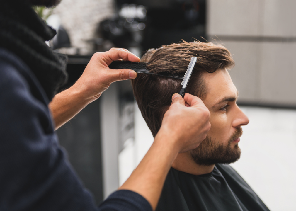 Client getting haircut by hairdresser