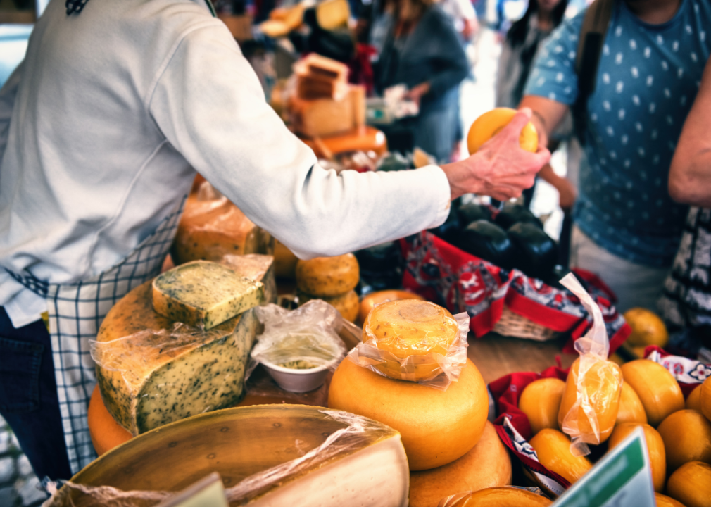 A cheese monger at a European farmers market