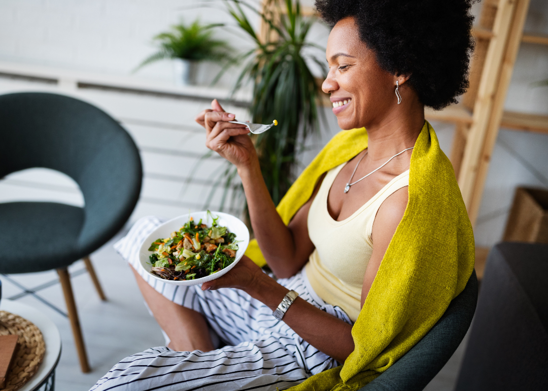 Woman eating healthy vegetable salad.