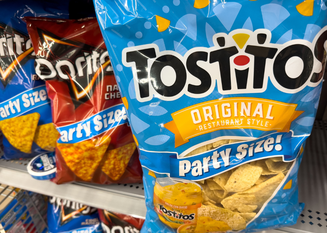 Tostitos bag corn chips on grocery store shelf.