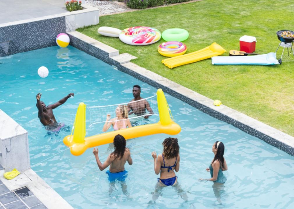 Friends playing pool volleyball.