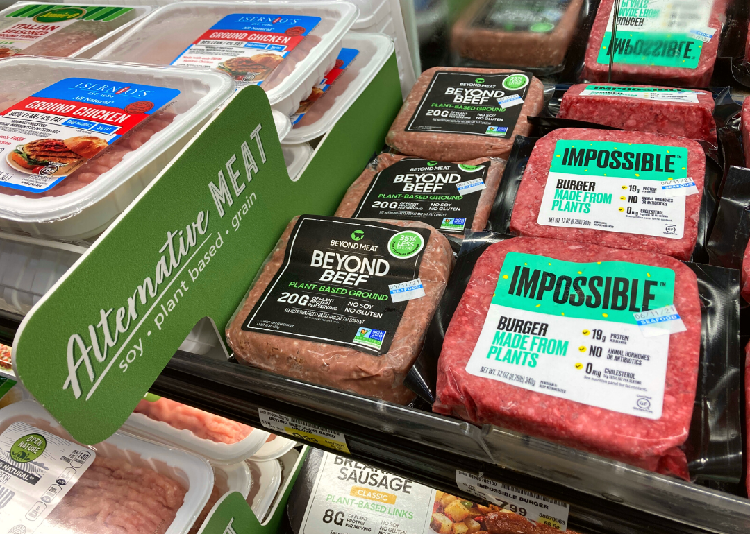 Beyond Meat and Impossible Foods burgers in supermarket.