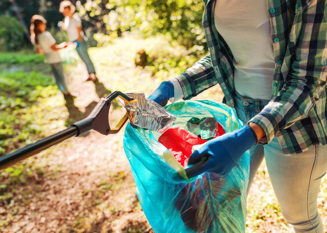 Volunteers cleaning up trash in park.