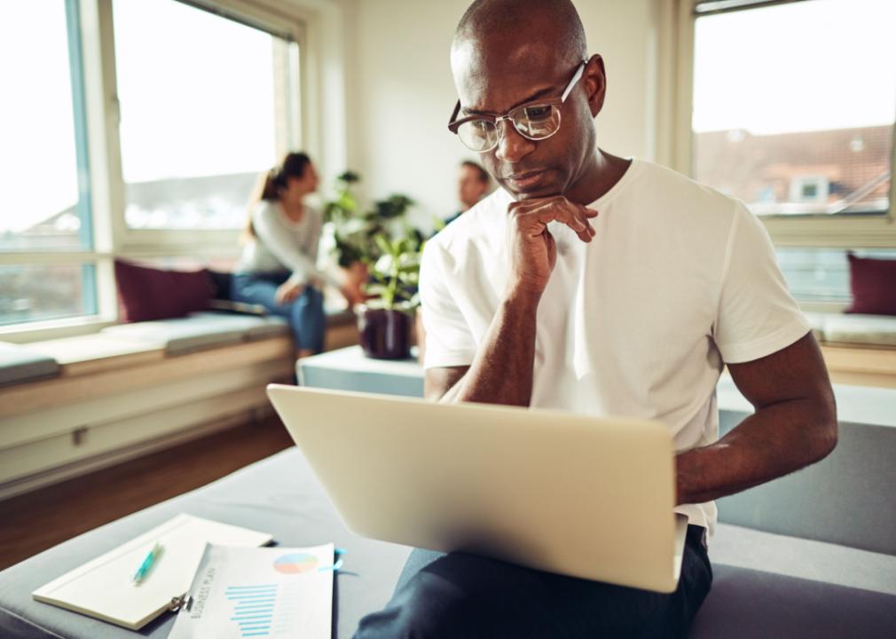 Focused businessman working on laptop.