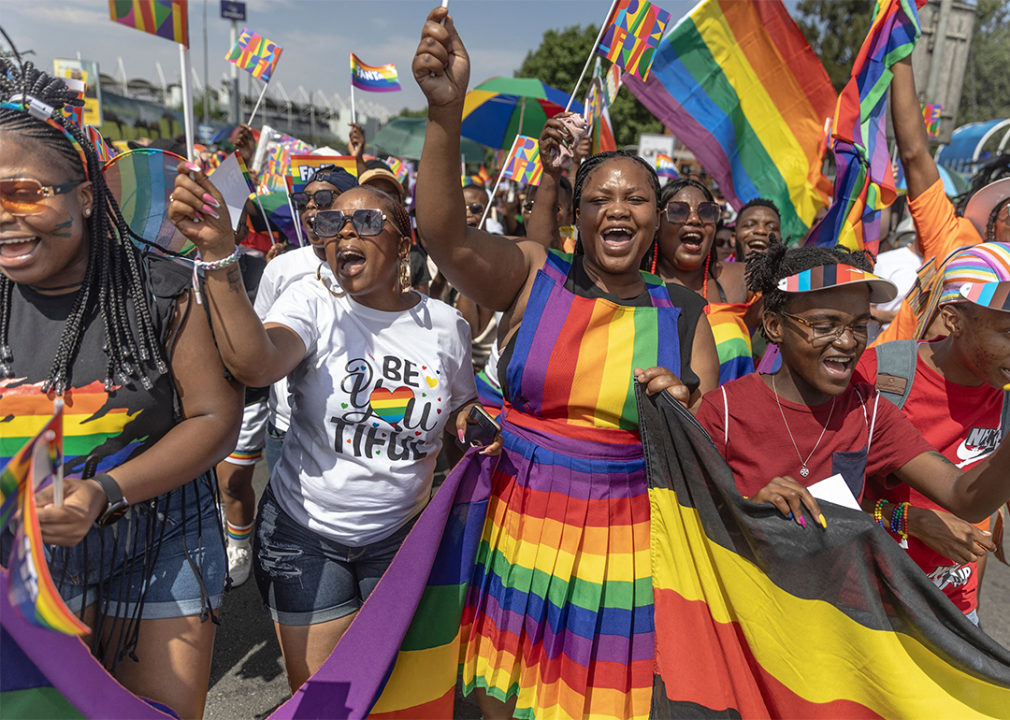 Attendees sing and wave flags in the Johannesburg Pride Parade.