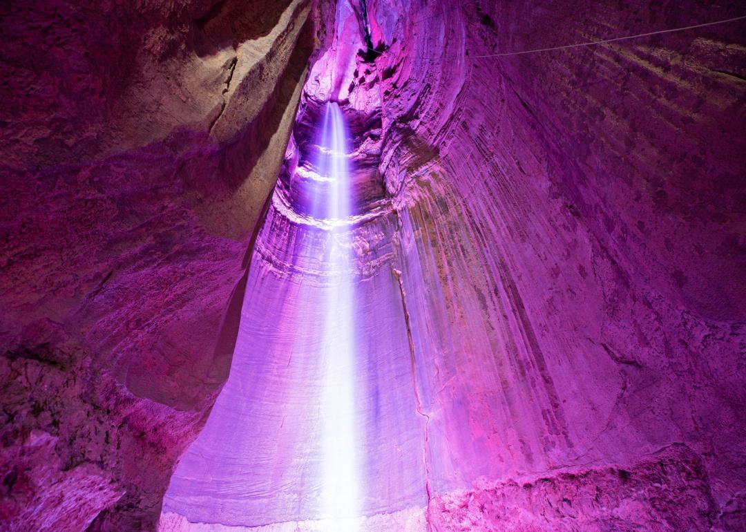 Cave waterfalls with magenta lighting.