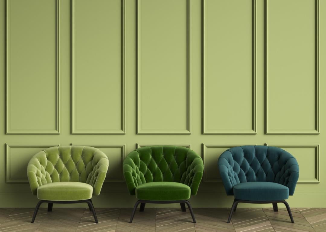 Three tufted green armchairs in classic interior with cozy space.