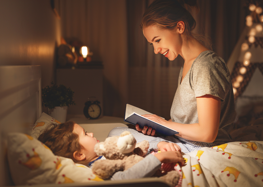 Mother reading to child at bedtime.