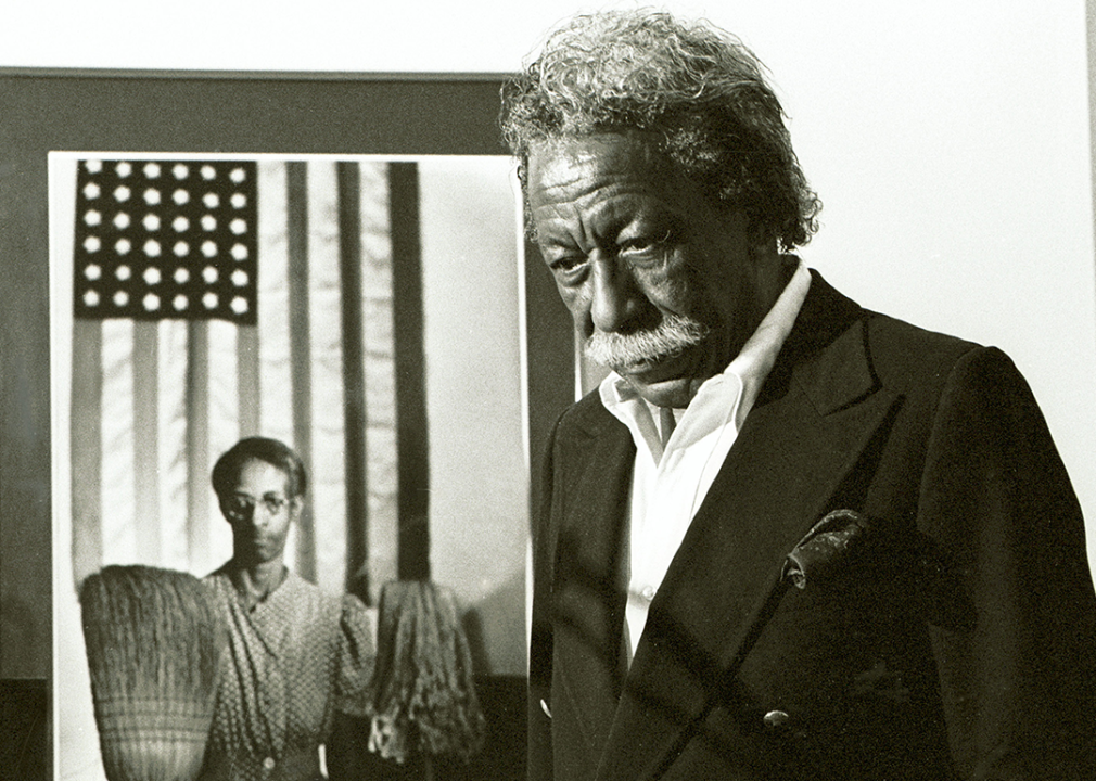 Gordon Parks stands next to one of his most famous images 