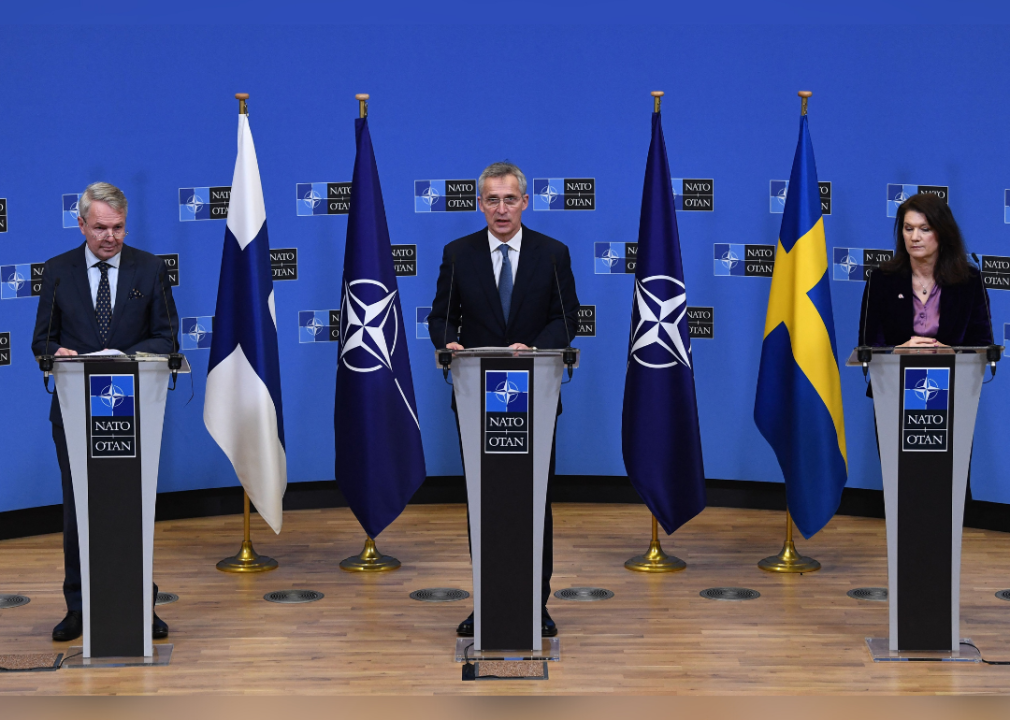 NATO Secretary Jens Stoltenberg standing with Pekka Haavisto of Finland and Ann Linde of Sweden