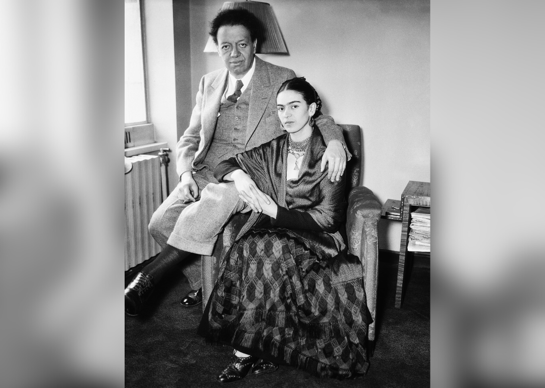 Diego Rivera and Frida Kahlo pose for a portrait.