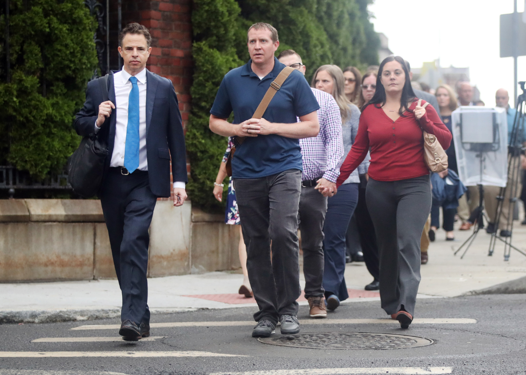 Families of Sandy Hook Elementary School shooting victims walk into court with lawyer