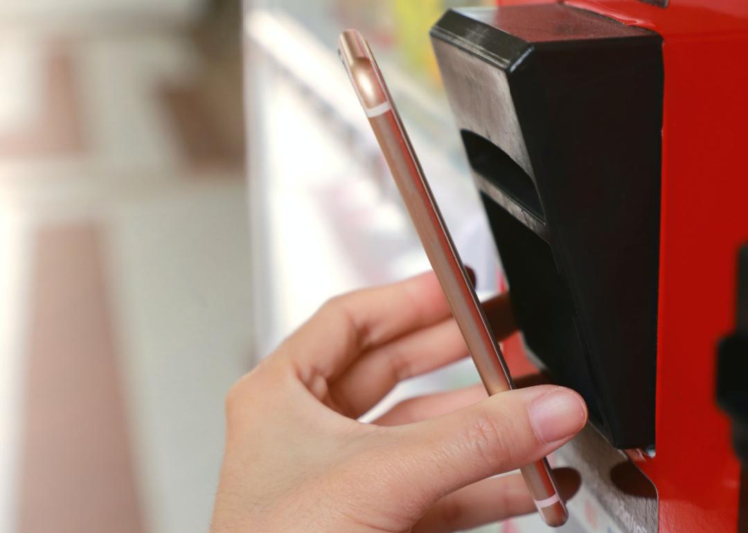 Smartphone being used on vending machine