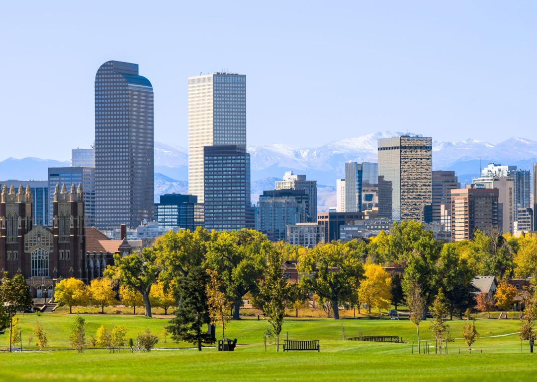 Downtown park and skyline with mountains in background.