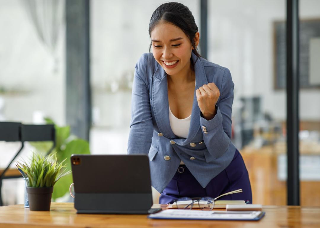 Smiling professional asian woman with positive fist gesture
