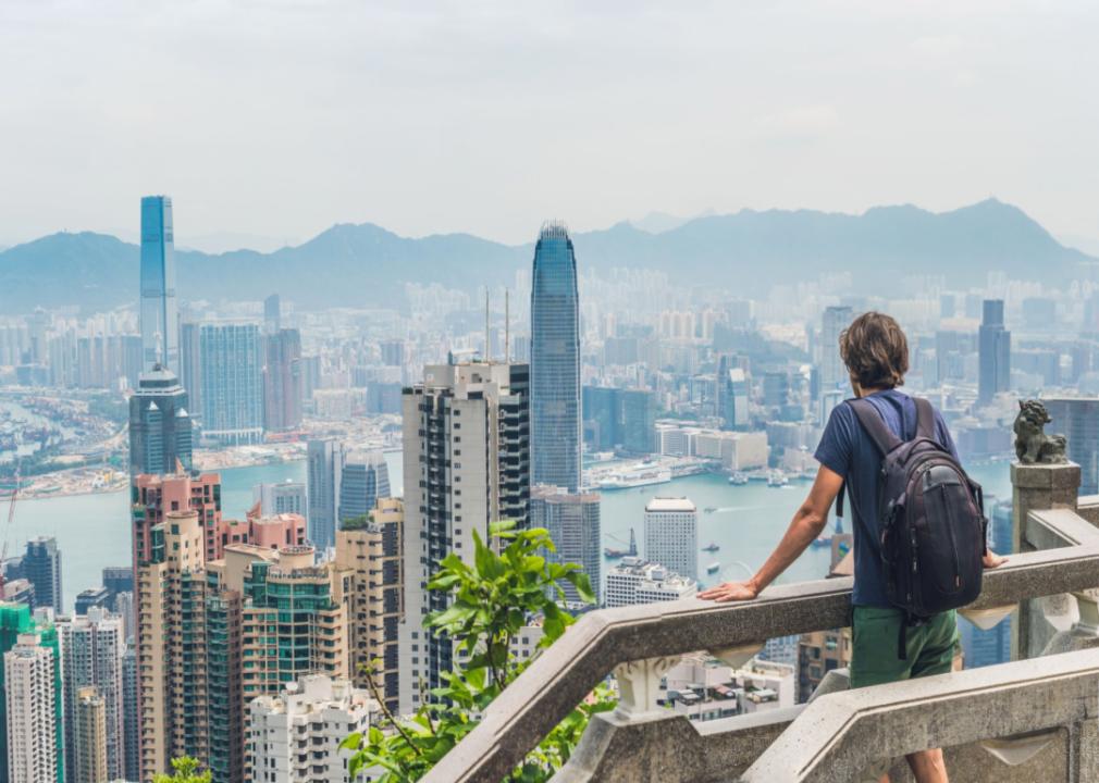 Person with backpack at peak of Victoria with harbor view