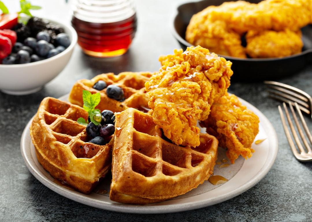 Waffles with fried chicken and maple syrup.