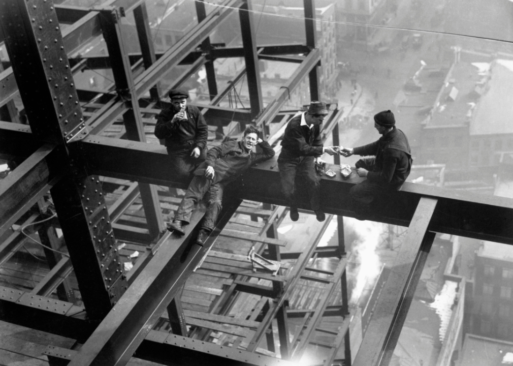 Workers eat lunch atop beam