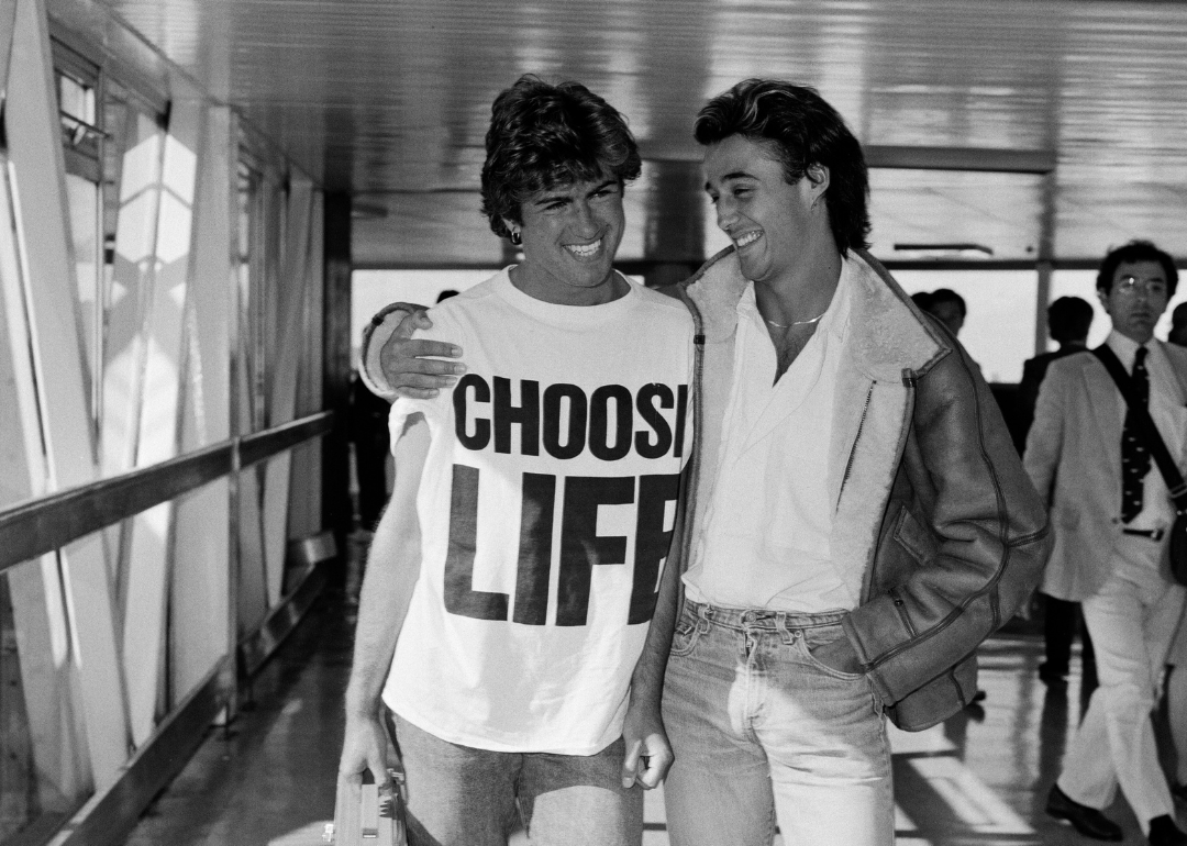 George Michael and Andrew Ridgeley arrive at airport.