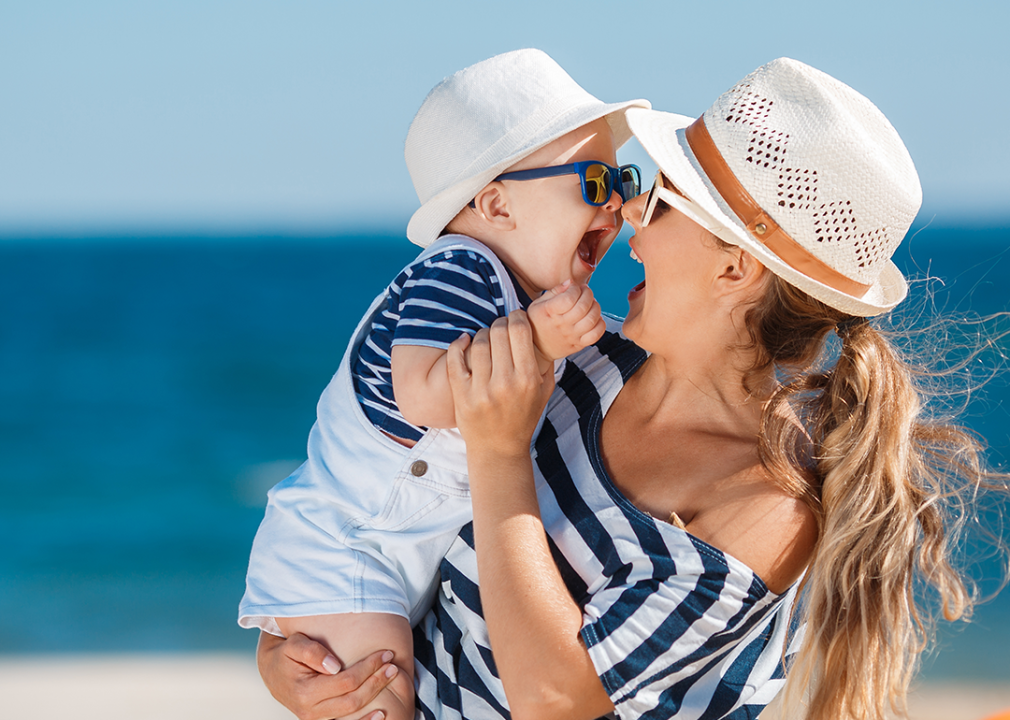 Mother with baby boy happy on beach.