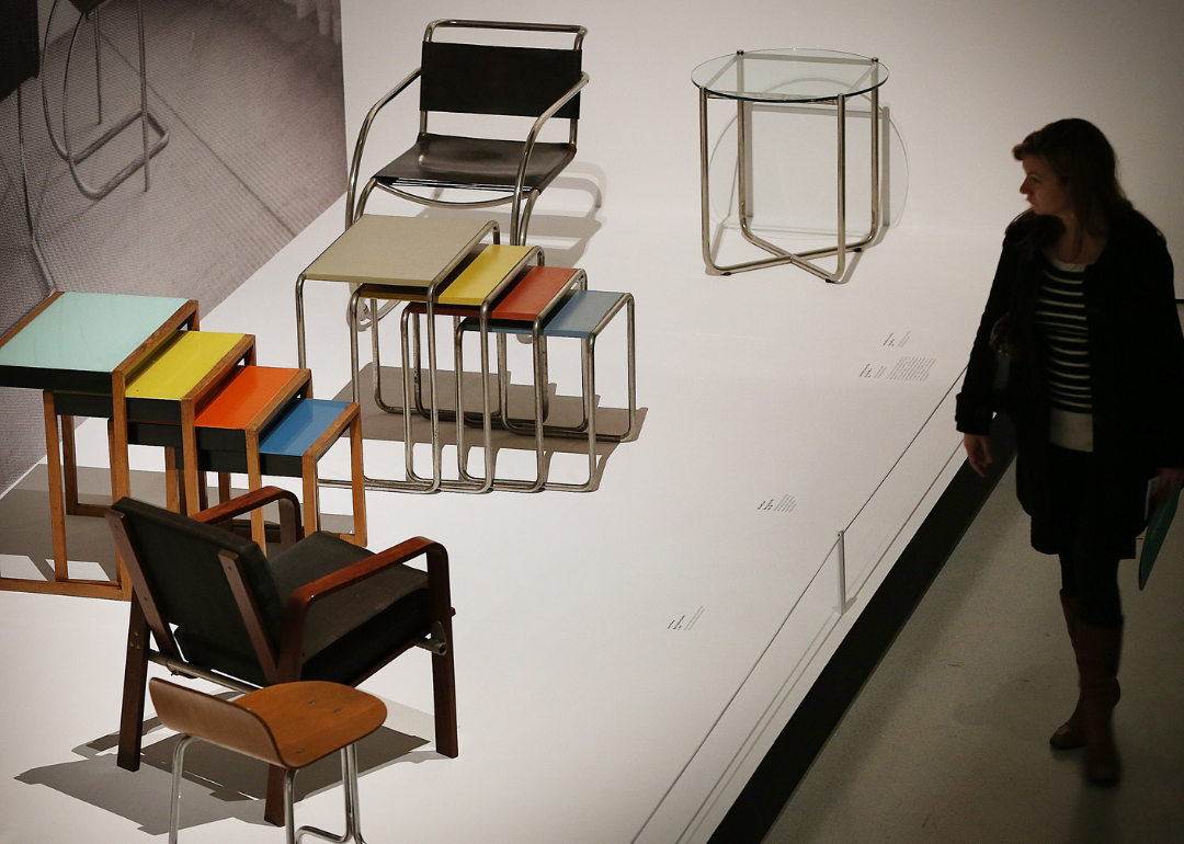 A visitor looks at tables and chairs on display at the 