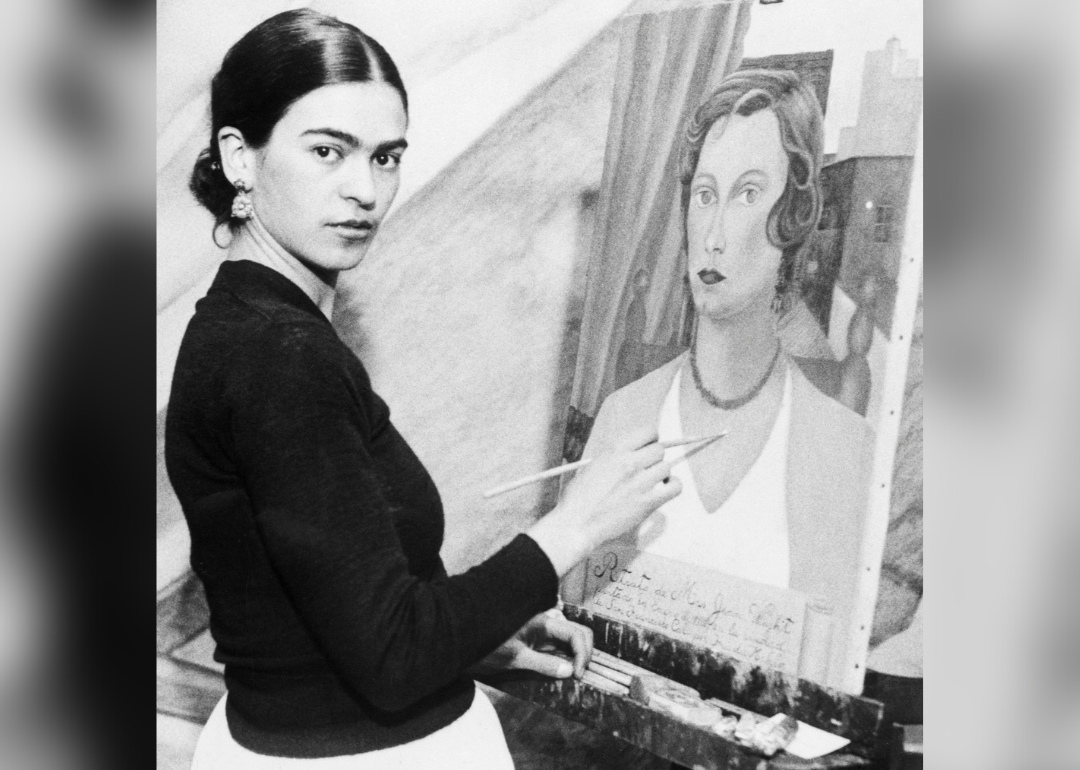 Frida Kahlo painting a portrait.