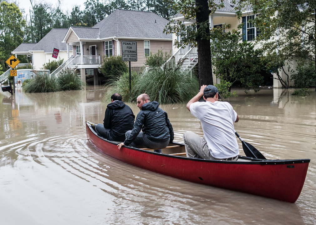 Residents canoe along a residential street in Columbia, South Carolina.