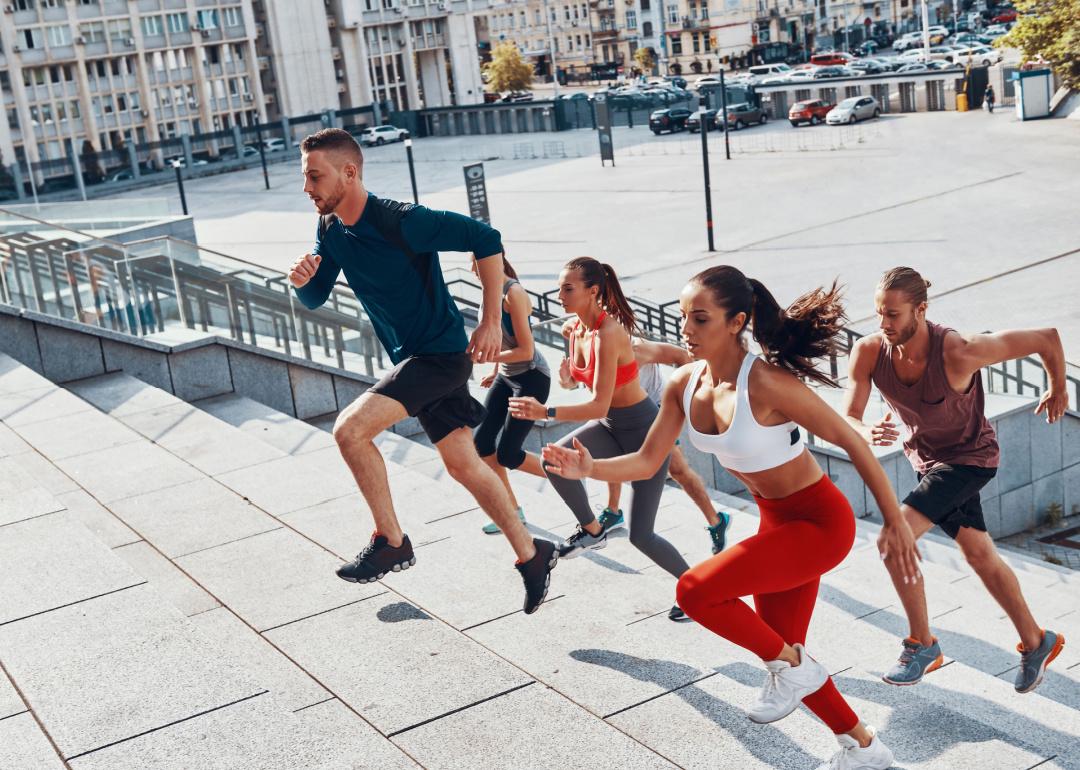 Group of people running up stairs.