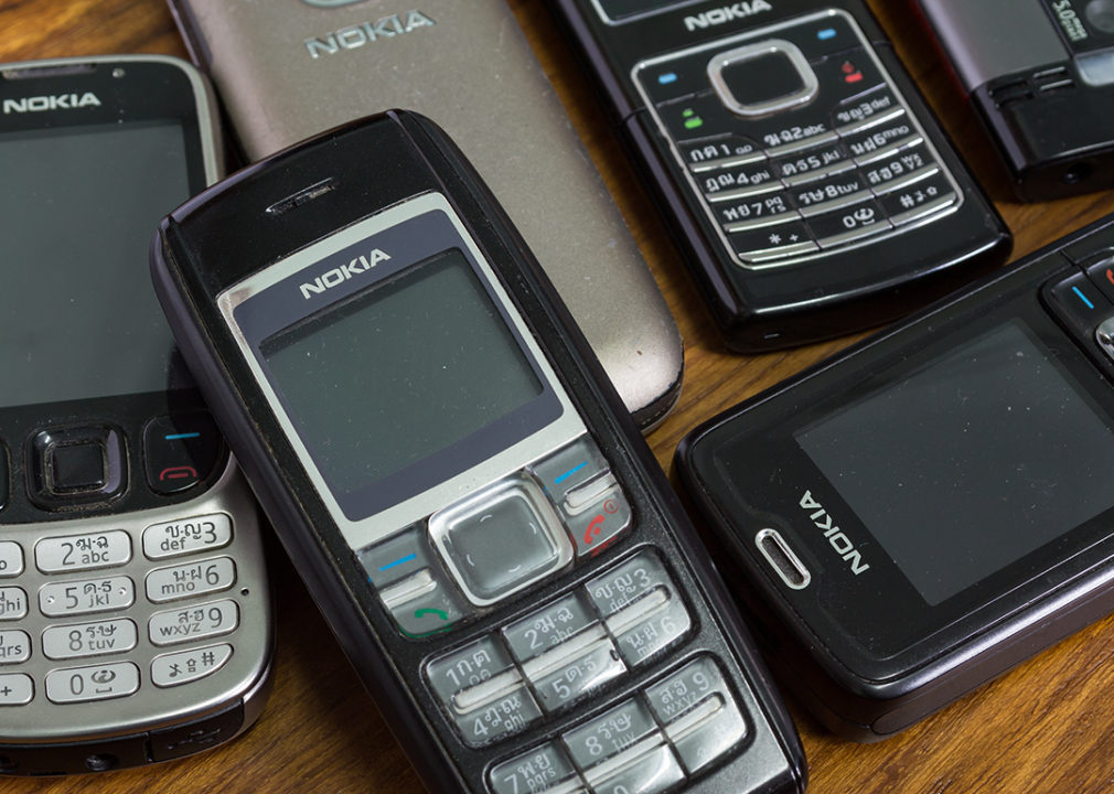 Assortment of Nokia phones on wood background.