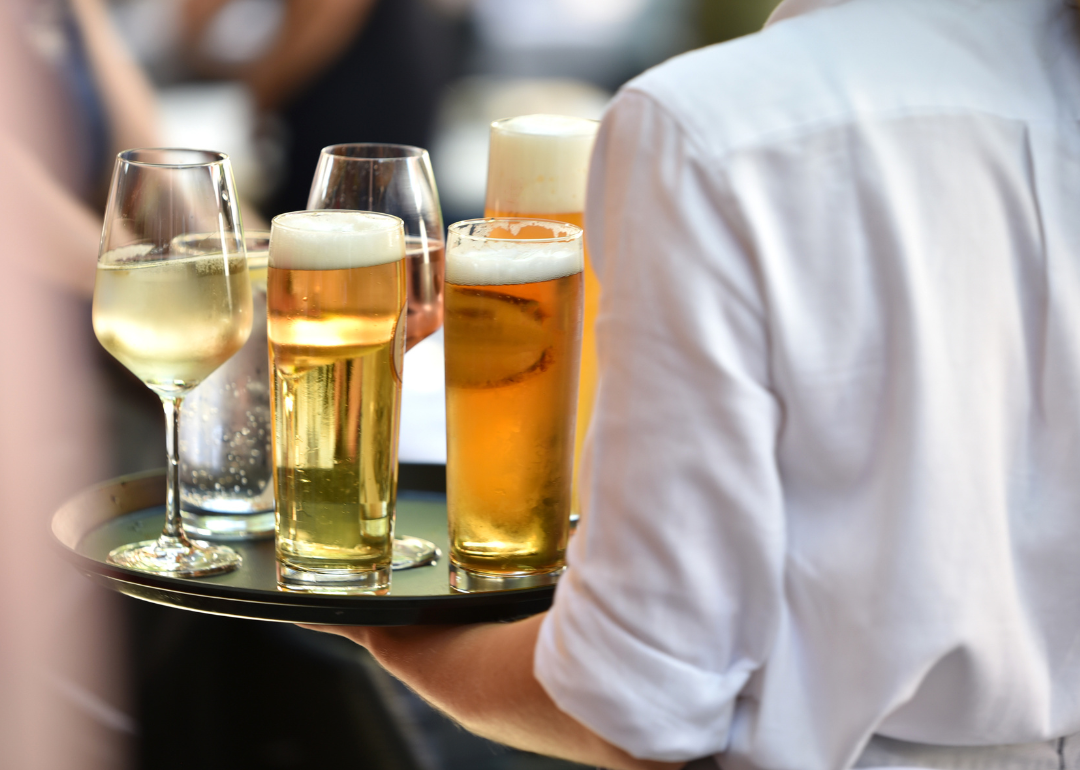 Person carrying drinks to table