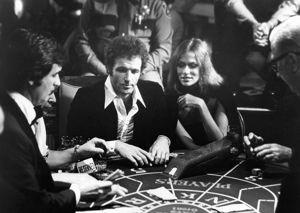 James Caan and Lauren Hutton at the card table in a scene from 