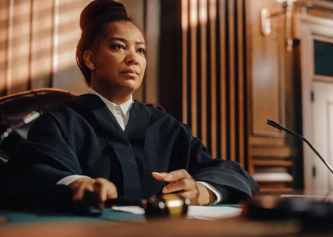 Woman judge with gavel in courtroom.