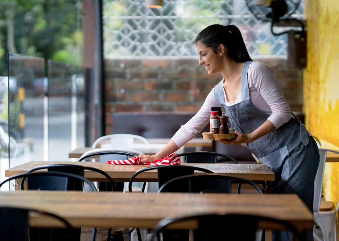 Woman cleaning tables