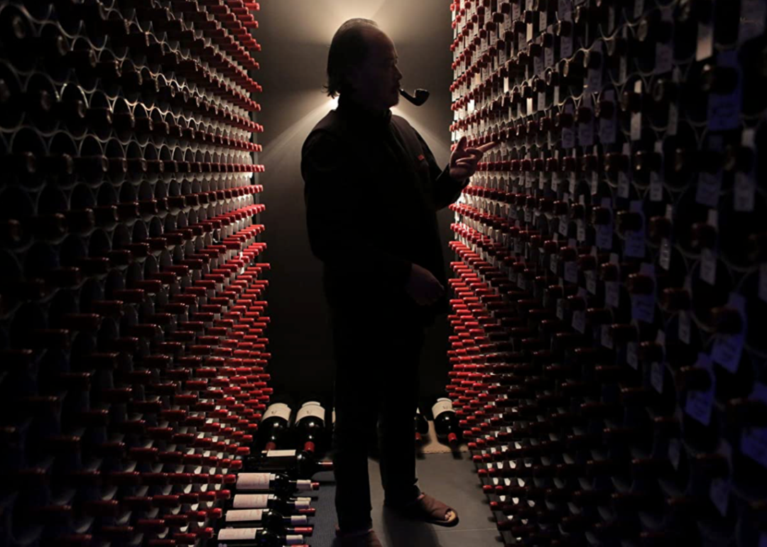 Still image of man in a wine cellar from 