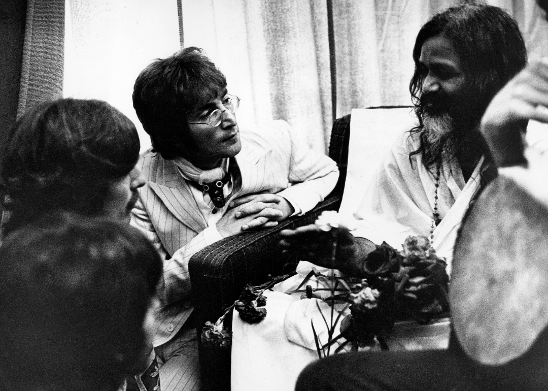John Lennon and Maharishi Mahesh Yogi and George Harrison in conversation.