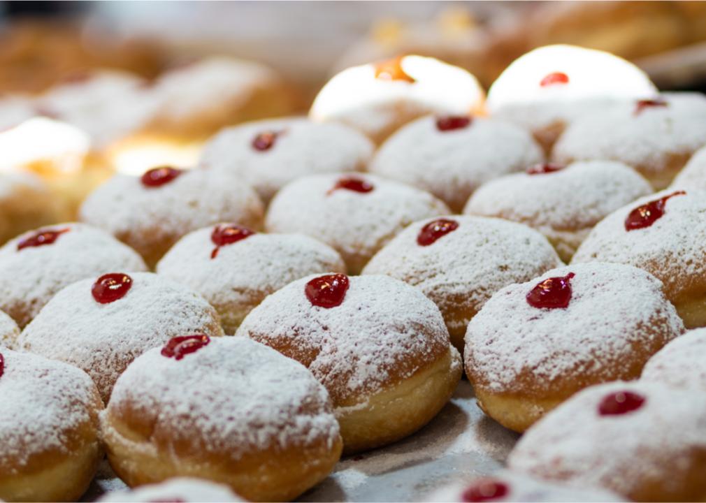 A close up of a batch of sufganiyot. 