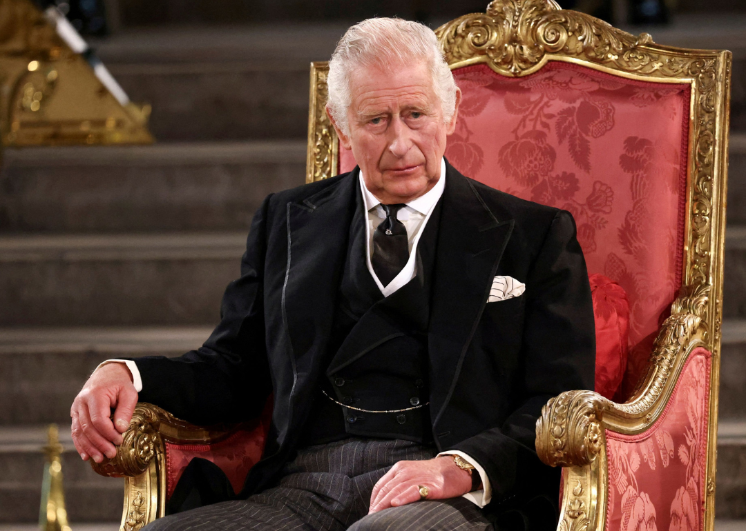 King Charles III seated at official event.